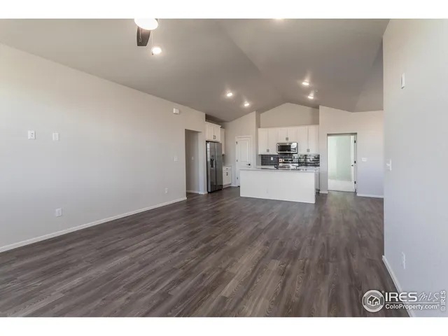 a view of a kitchen with a sink and a refrigerator