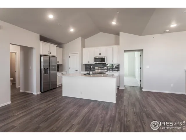 a view of kitchen view wooden cabinets and stainless steel appliances