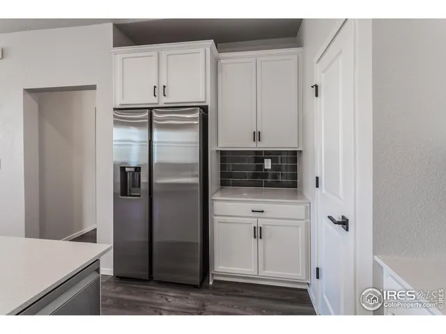 a kitchen with stainless steel appliances a refrigerator and cabinets
