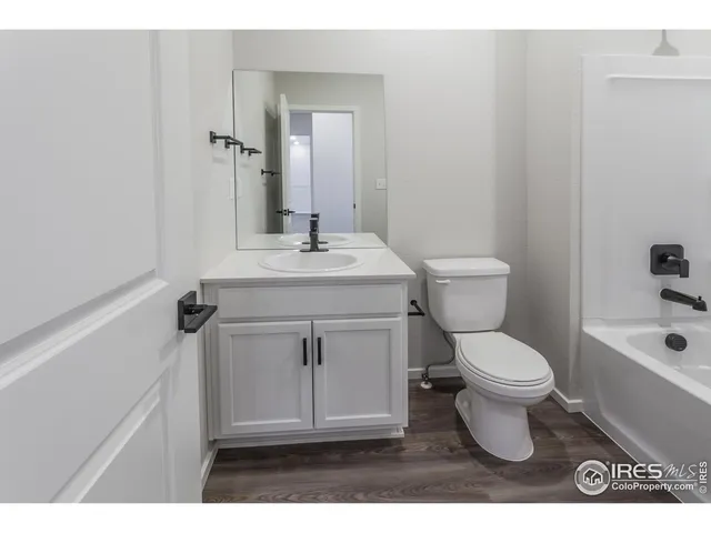 a bathroom with a sink toilet a mirror and shower