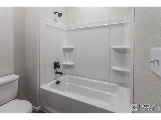 a bathroom with a bathtub and a toilet