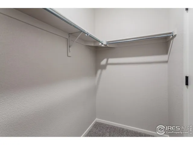 a spacious bathroom with a double vanity sink a mirror and shower