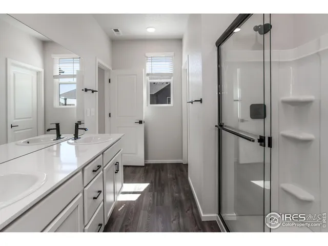 a bathroom with a glass shower door