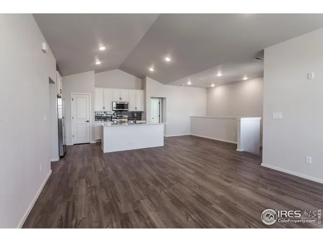 a view of a kitchen with a sink and a refrigerator