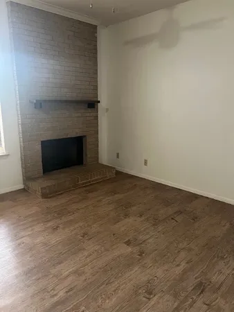 a view of empty room with a fireplace