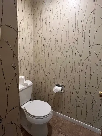 a bathroom with a granite countertop sink a mirror and a shower