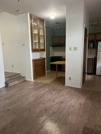 an empty room with closet and windows