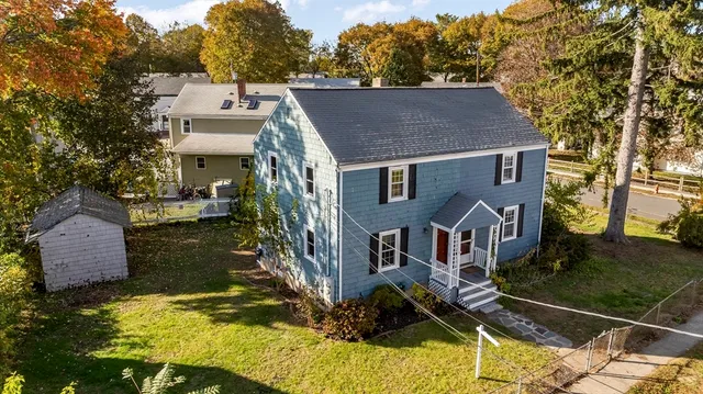 a aerial view of a house with a yard
