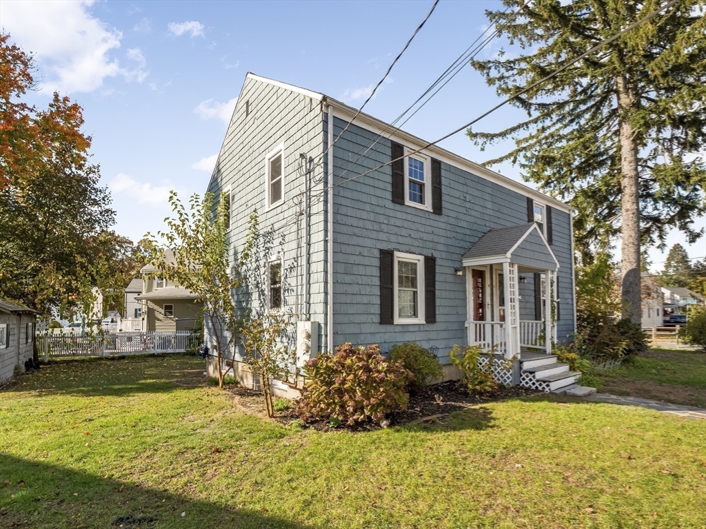 22 Jefferson Road, Unit 22 Wakefield, MA 01880 - Photo 17 of 22 a front view of house with yard and trees around
