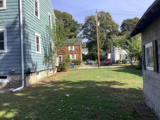 a view of yard with swimming pool and green space