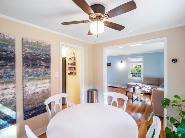 a living room with furniture a chandelier and a dining table