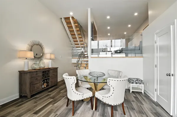 a dining room with furniture and wooden floor