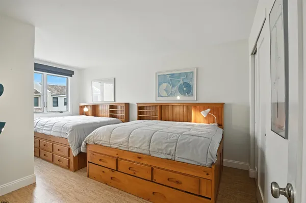a bedroom with a bed and painting on the wall