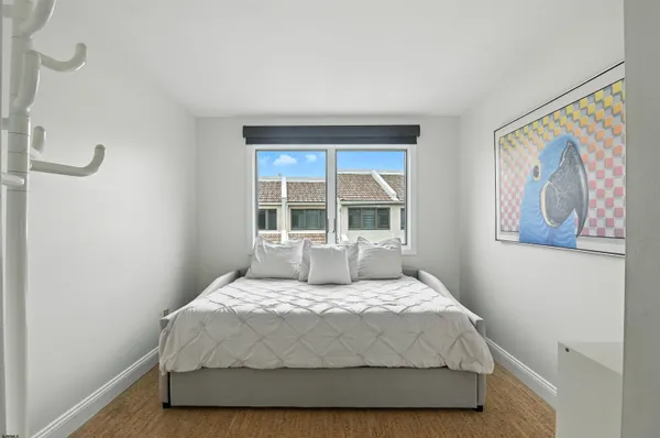 a large bed sitting in a bedroom next to a window