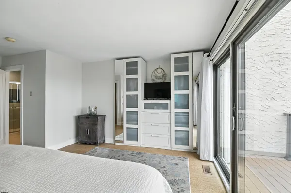 a bedroom with a bed and a flat tv screen