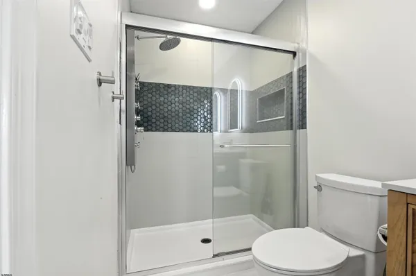 a bathroom with a shower and toilet