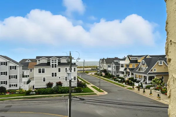 a view of buildings with cars parked