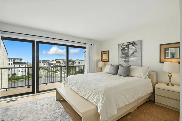 a bedroom with a large bed and a large window