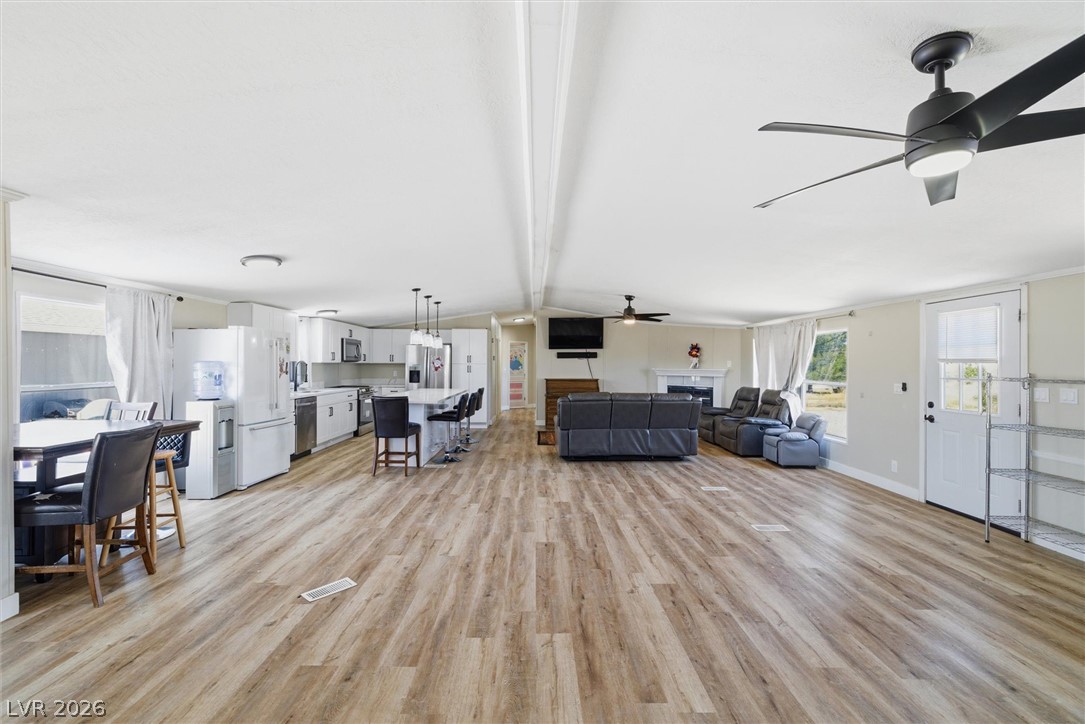 4331 Retread Road Pahrump, NV 89048 - Photo 12 of 31 An open concept living area seamlessly integrates the kitchen, dining, and living spaces with durable flooring.