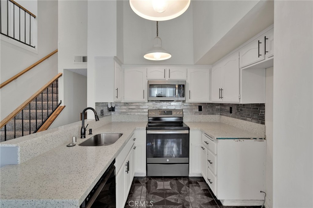 11659 Pepper Lane Apple Valley, CA 92308 - Photo 12 of 50 a kitchen with a sink stove and cabinets