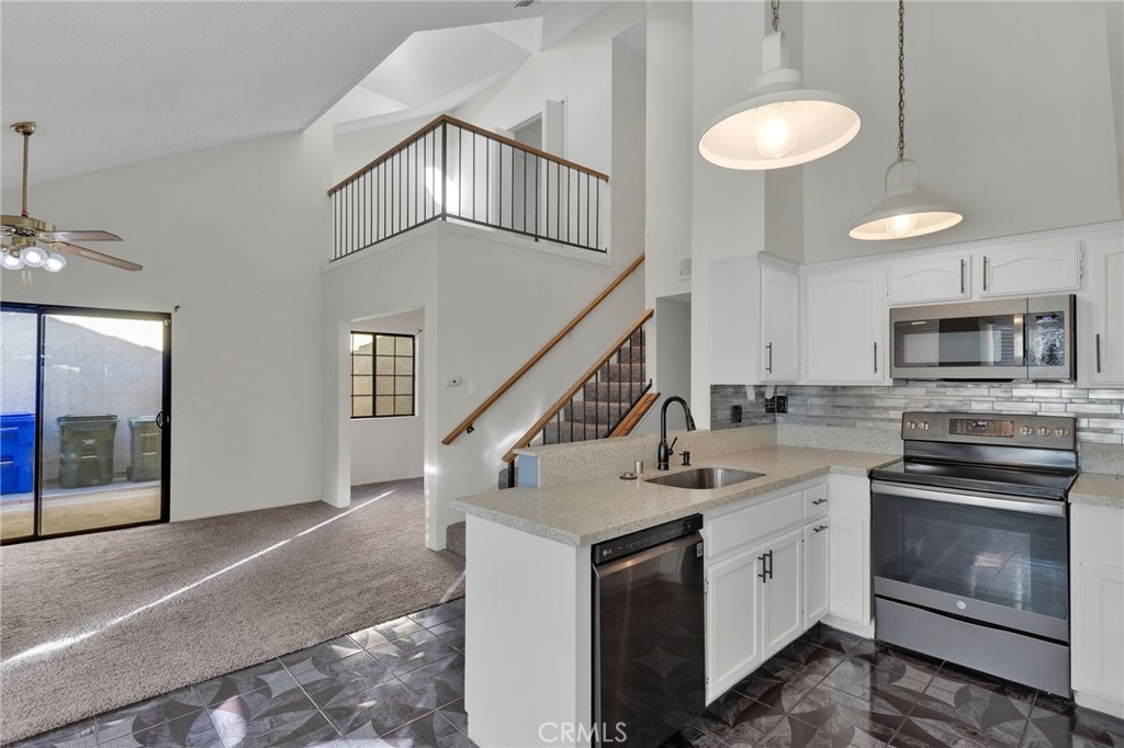11659 Pepper Lane Apple Valley, CA 92308 - Photo 13 of 50 a kitchen with a sink a stove and oven