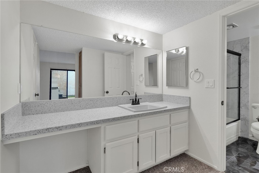 11659 Pepper Lane Apple Valley, CA 92308 - Photo 20 of 50 a bathroom with a sink and a mirror