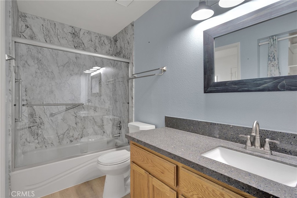 11659 Pepper Lane Apple Valley, CA 92308 - Photo 33 of 50 a bathroom with a granite countertop sink a toilet and shower