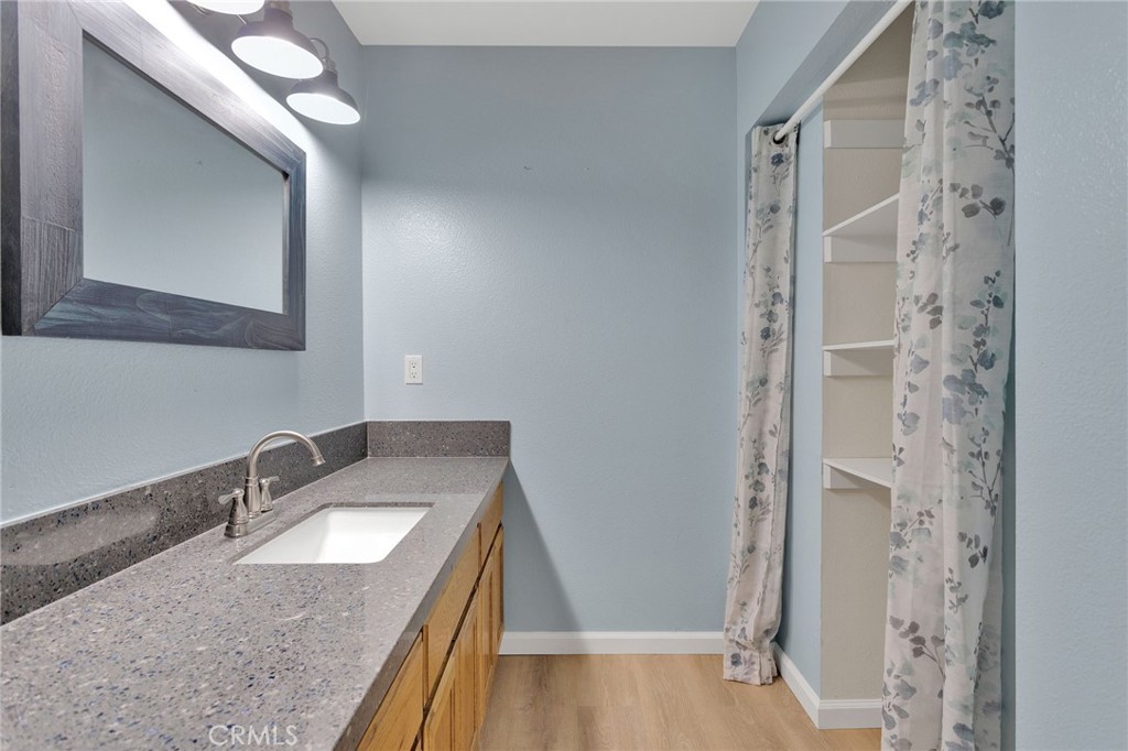 11659 Pepper Lane Apple Valley, CA 92308 - Photo 34 of 50 a bathroom with a granite countertop sink and a mirror