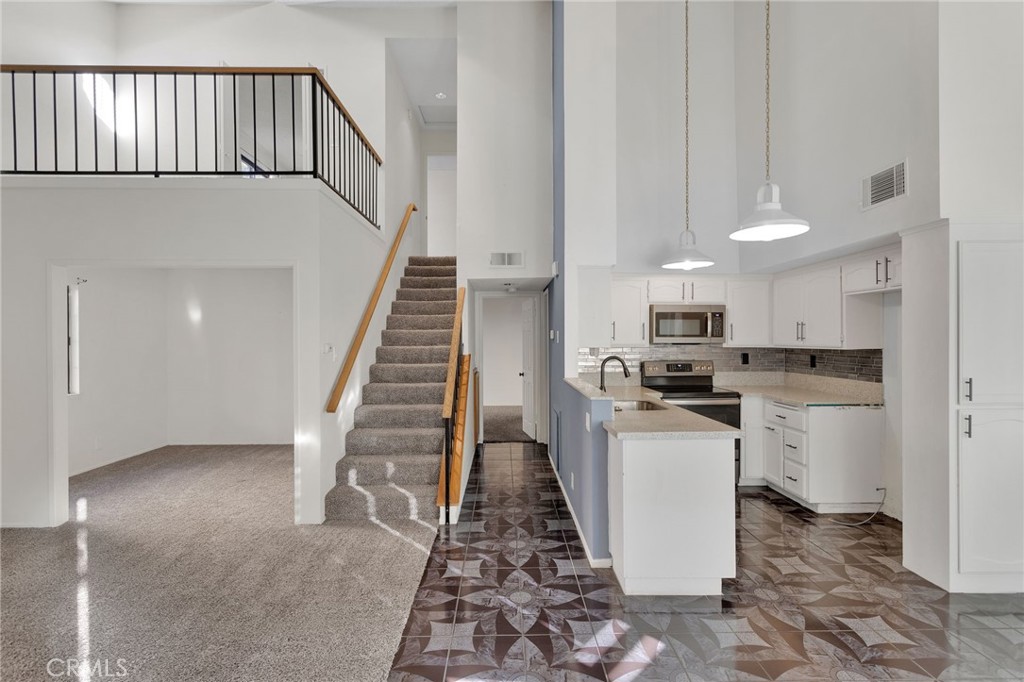 11659 Pepper Lane Apple Valley, CA 92308 - Photo 4 of 50 a view of a kitchen with wooden floor and electronic appliances