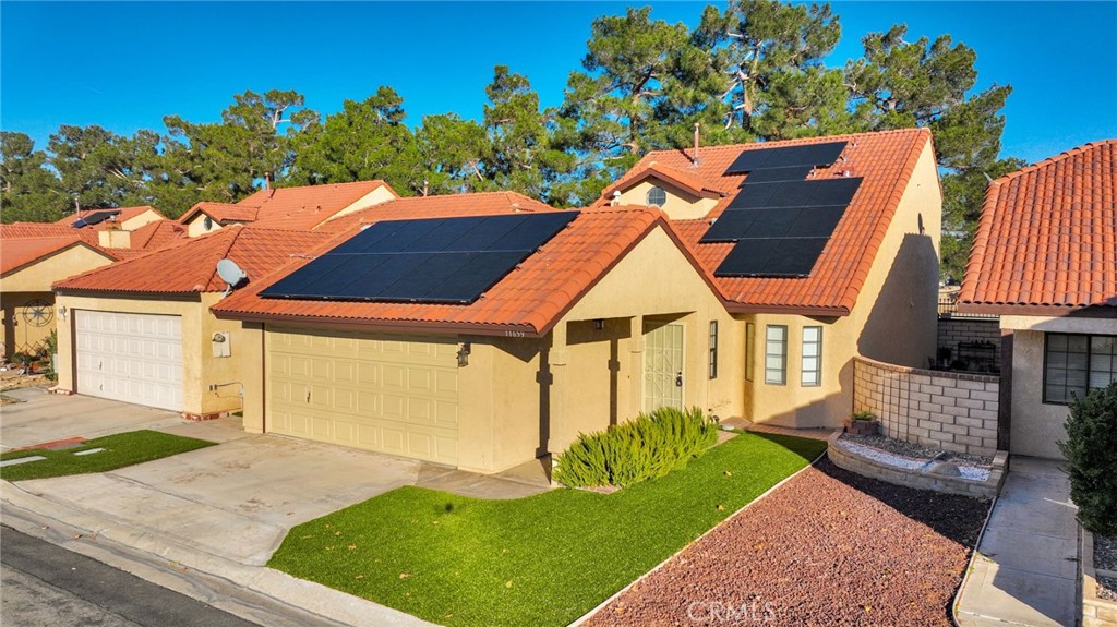 11659 Pepper Lane Apple Valley, CA 92308 - Photo 43 of 50 a view of house with backyard and a garden