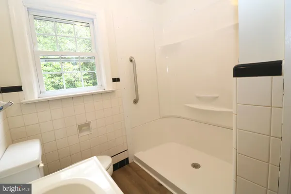 a bathroom with a tub and window