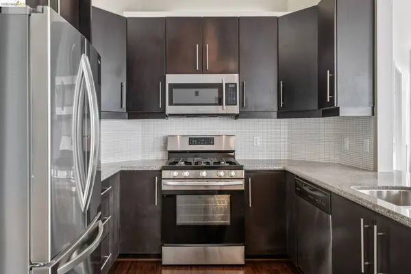 a kitchen with stainless steel appliances wooden cabinets and a stove