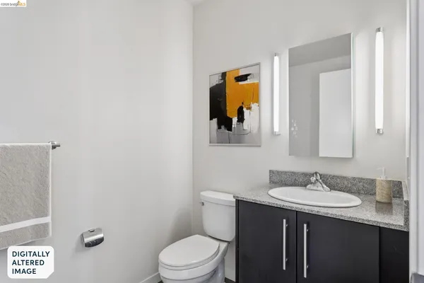a bathroom with a sink vanity and toilet