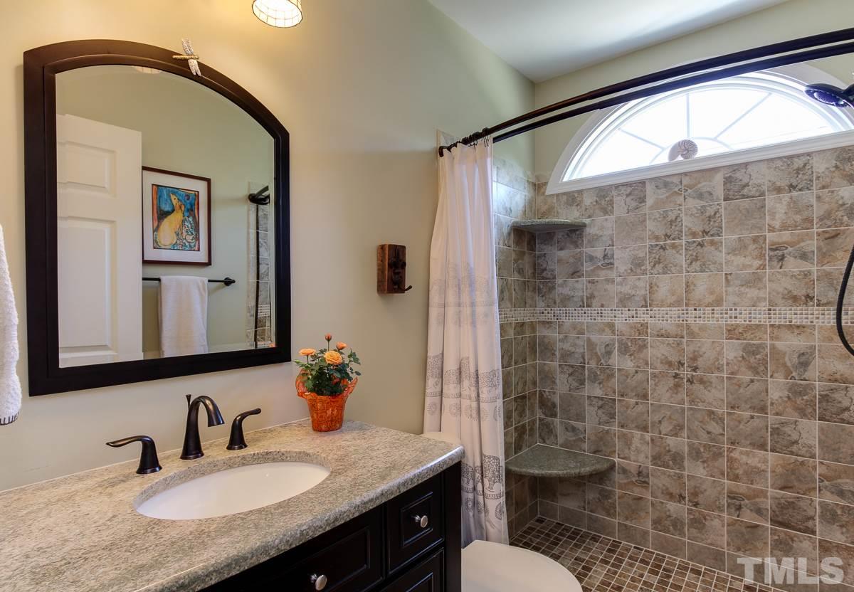 225 Cooke Street Raleigh, NC 27601 - Photo 9 of 24 a bathroom with a granite countertop sink toilet and shower
