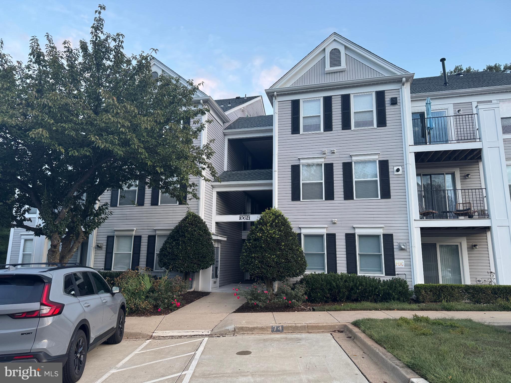 Charming apartment complex with lush greenery.