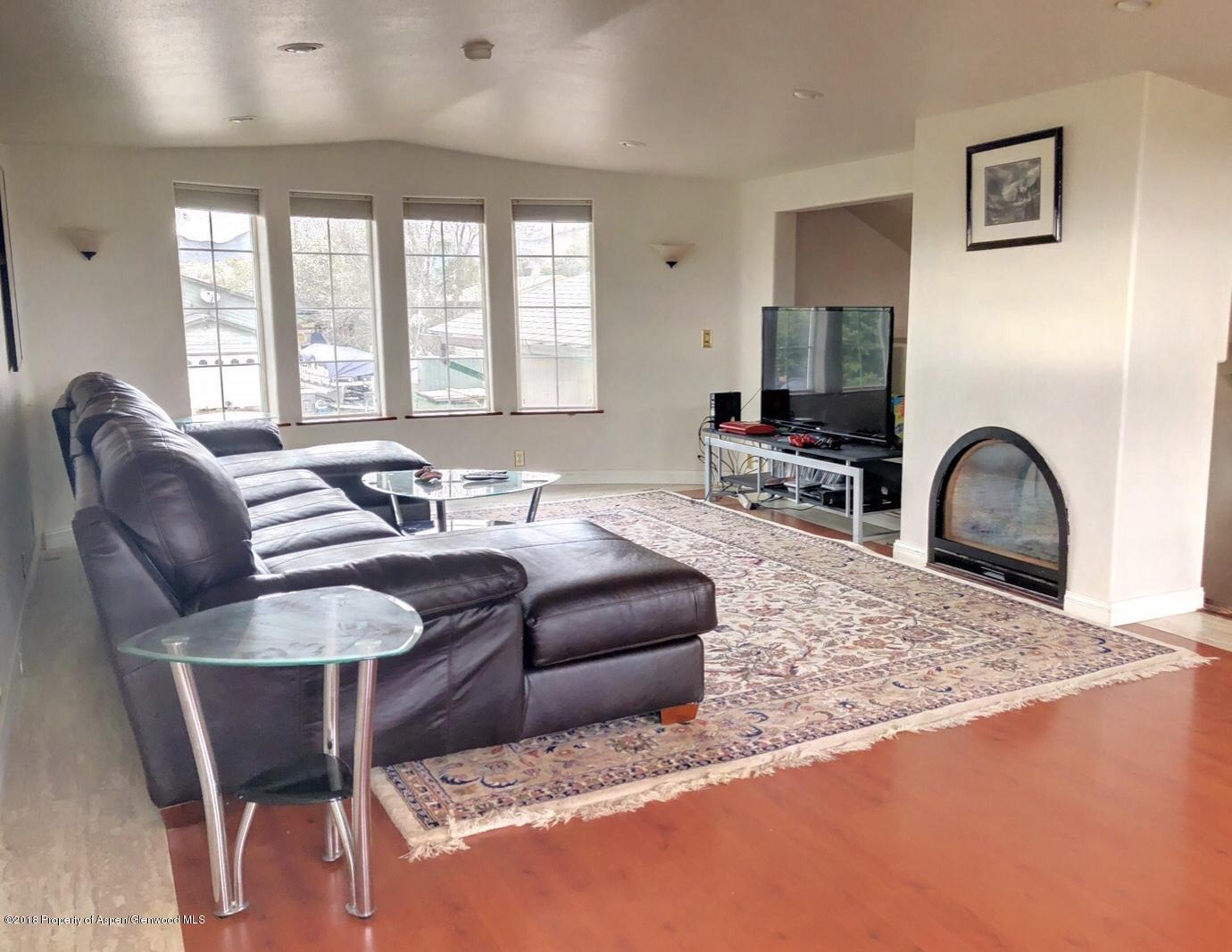 1017 West 5th Street Rifle, CO 81650 - Photo 1 of 22 a living room with furniture a flat screen tv and a large window
