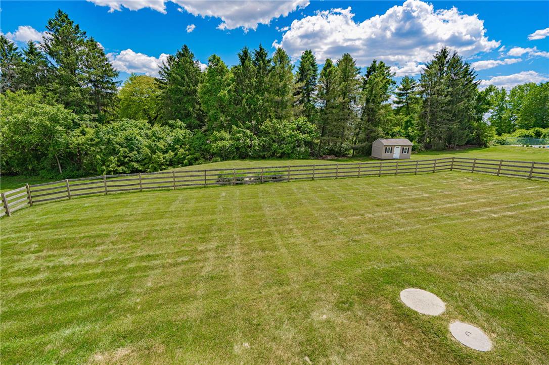 6000 Pond View Terrace Bath, PA 18014 - Photo 53 of 69 A spacious, fenced yard with a storage shed, offering ample green space and privacy.