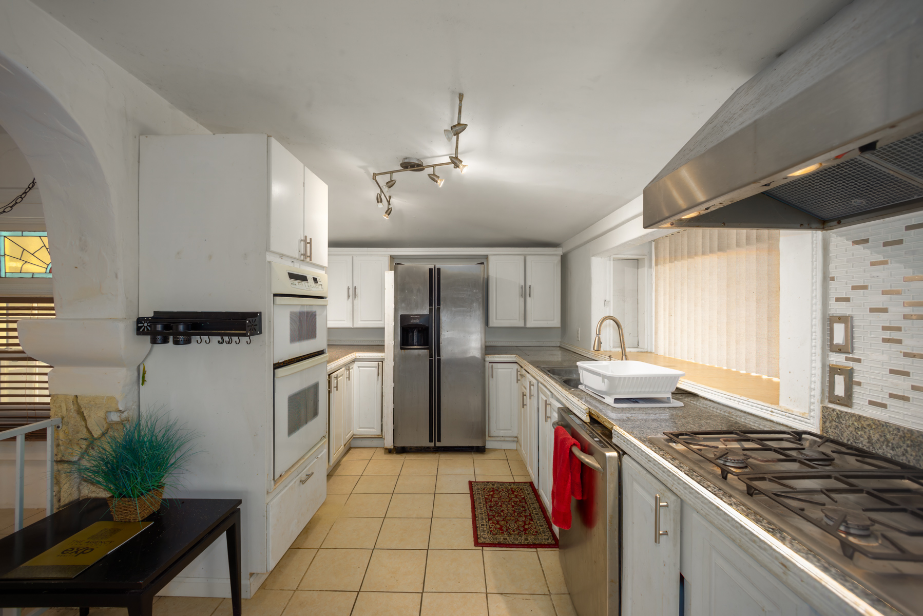 84-5125 Hawaiʻi Belt Road Captain Cook, HI 96704 - Photo 14 of 27 a kitchen with a stove sink and refrigerator