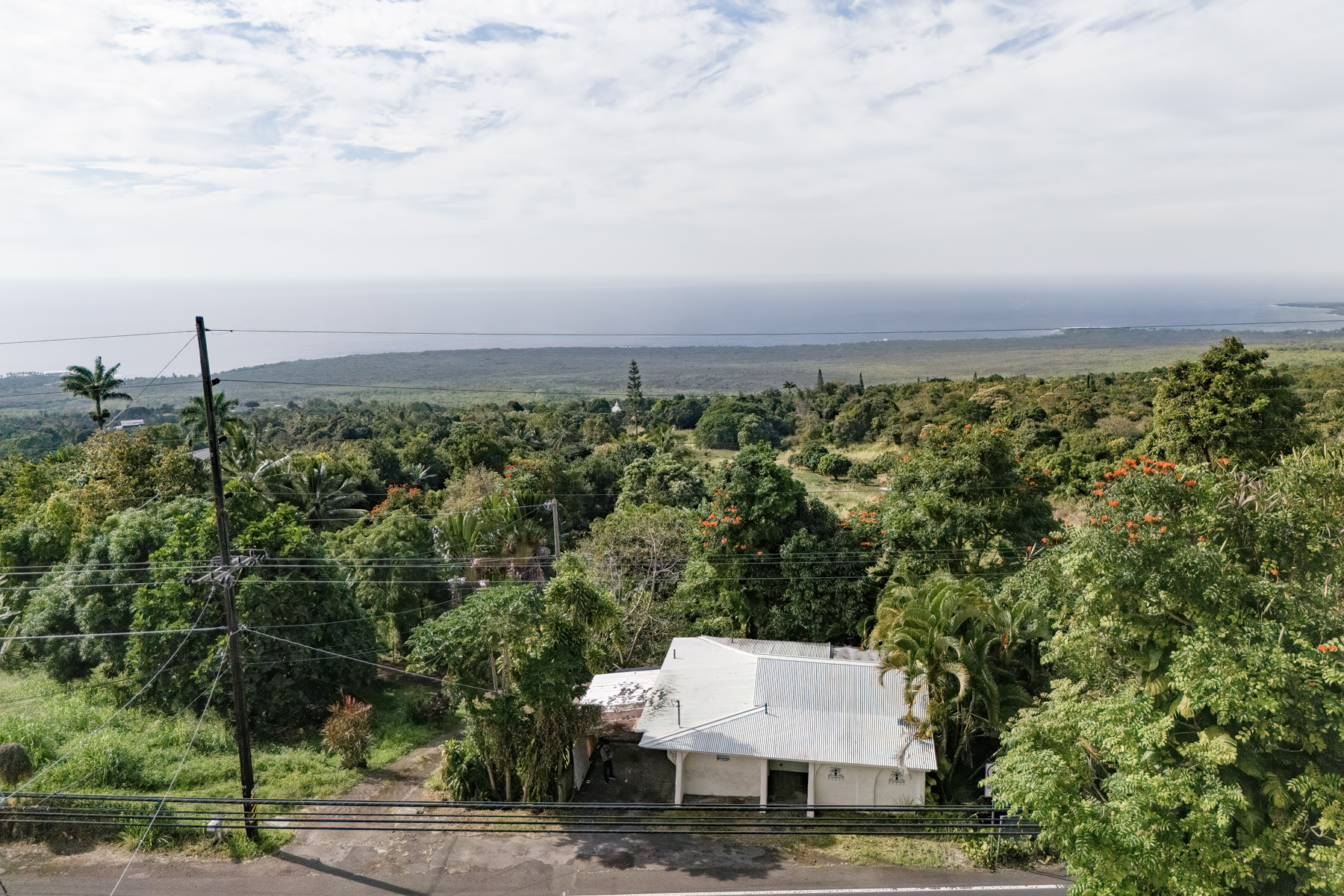 84-5125 Hawaiʻi Belt Road Captain Cook, HI 96704 - Photo 27 of 27 an aerial view of a house with a yard and mountain view in back