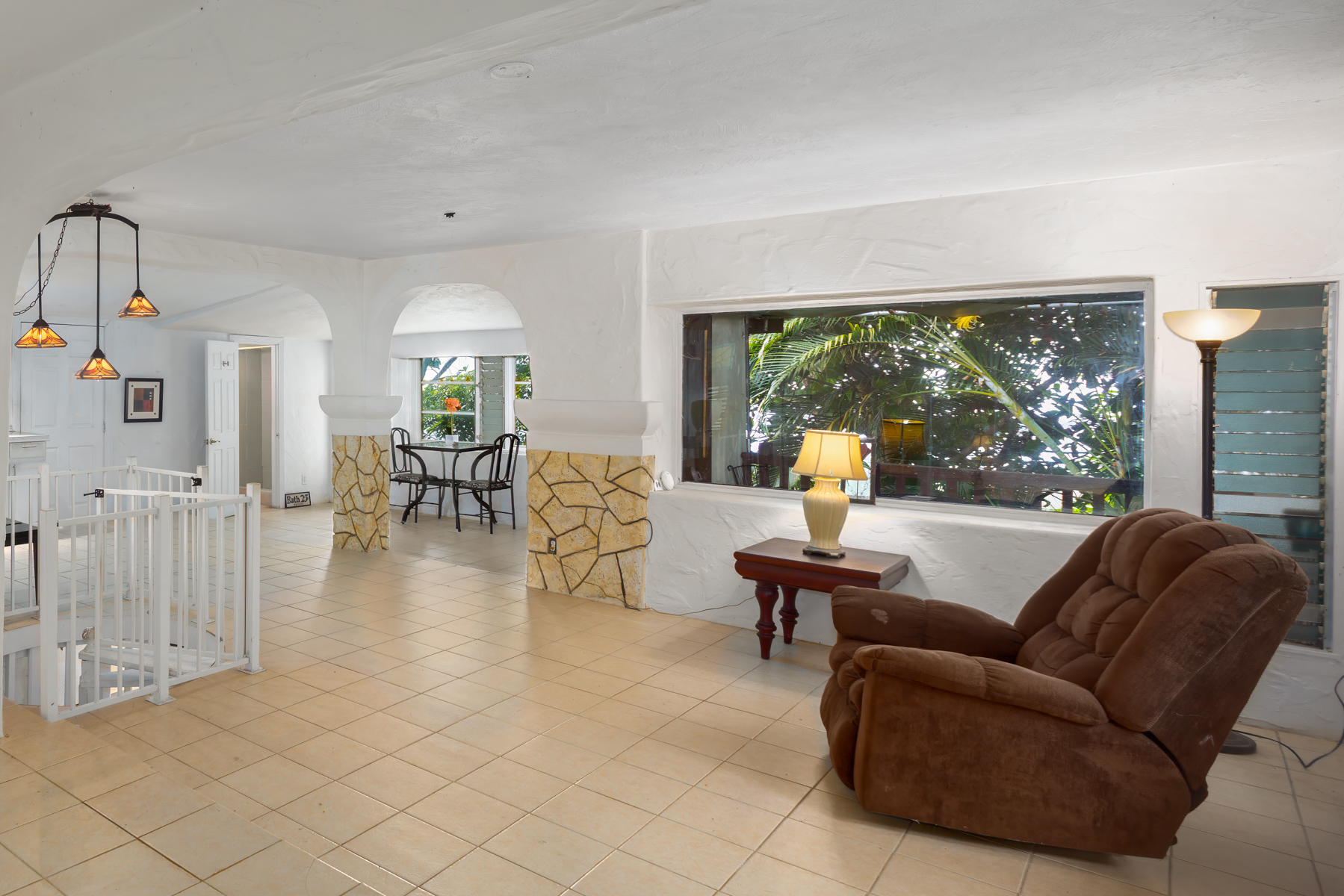 84-5125 Hawaiʻi Belt Road Captain Cook, HI 96704 - Photo 5 of 27 a living room with furniture and a large window