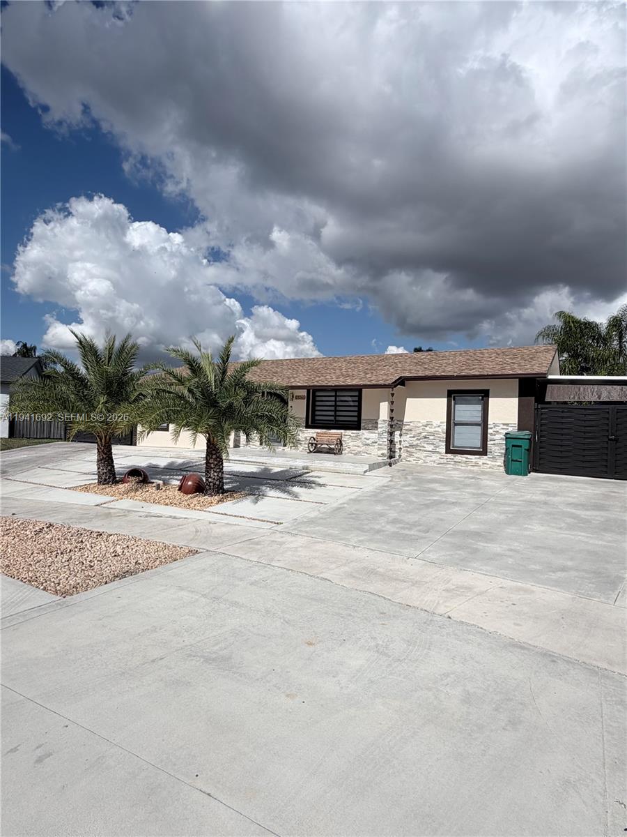 a view of house with yard and entertaining space