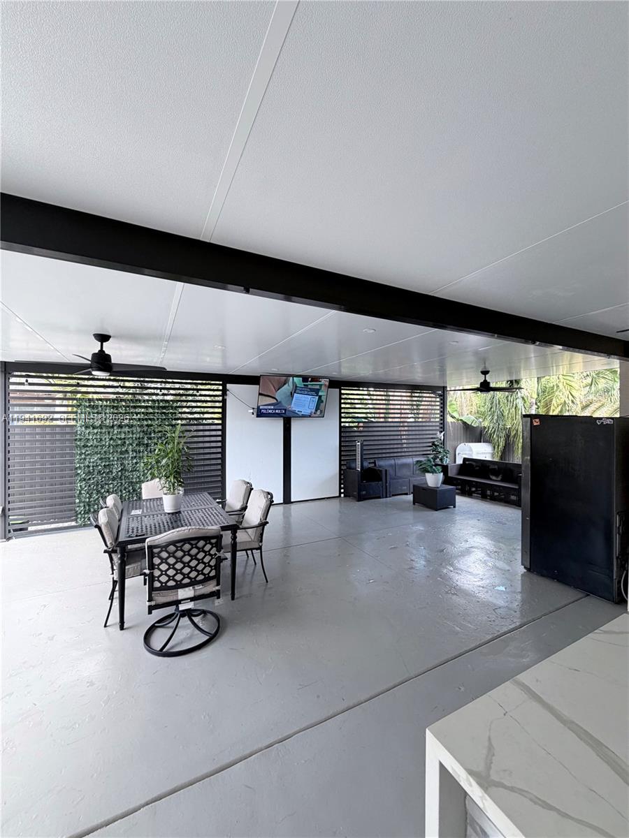 13261 Southwest 260th Terrace Homestead, FL 33032 - Photo 12 of 36 a living room with furniture and a flat screen tv