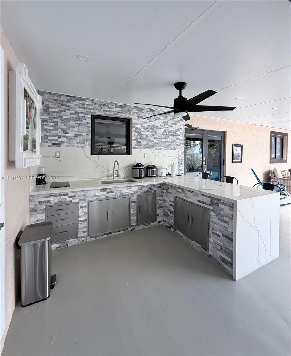 13261 Southwest 260th Terrace Homestead, FL 33032 - Photo 13 of 36 a kitchen with stainless steel appliances a sink stove and cabinets