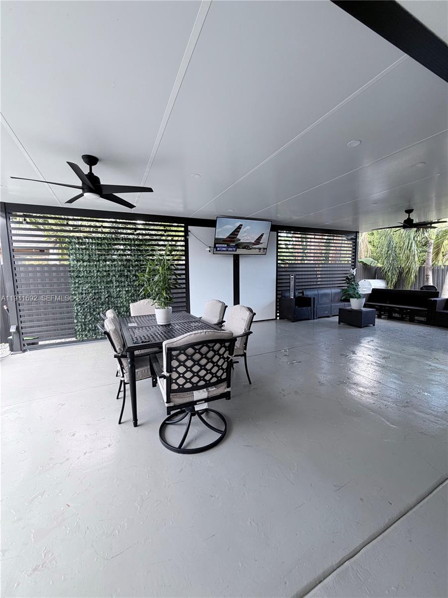 13261 Southwest 260th Terrace Homestead, FL 33032 - Photo 14 of 36 a dining room with furniture and a floor to ceiling window