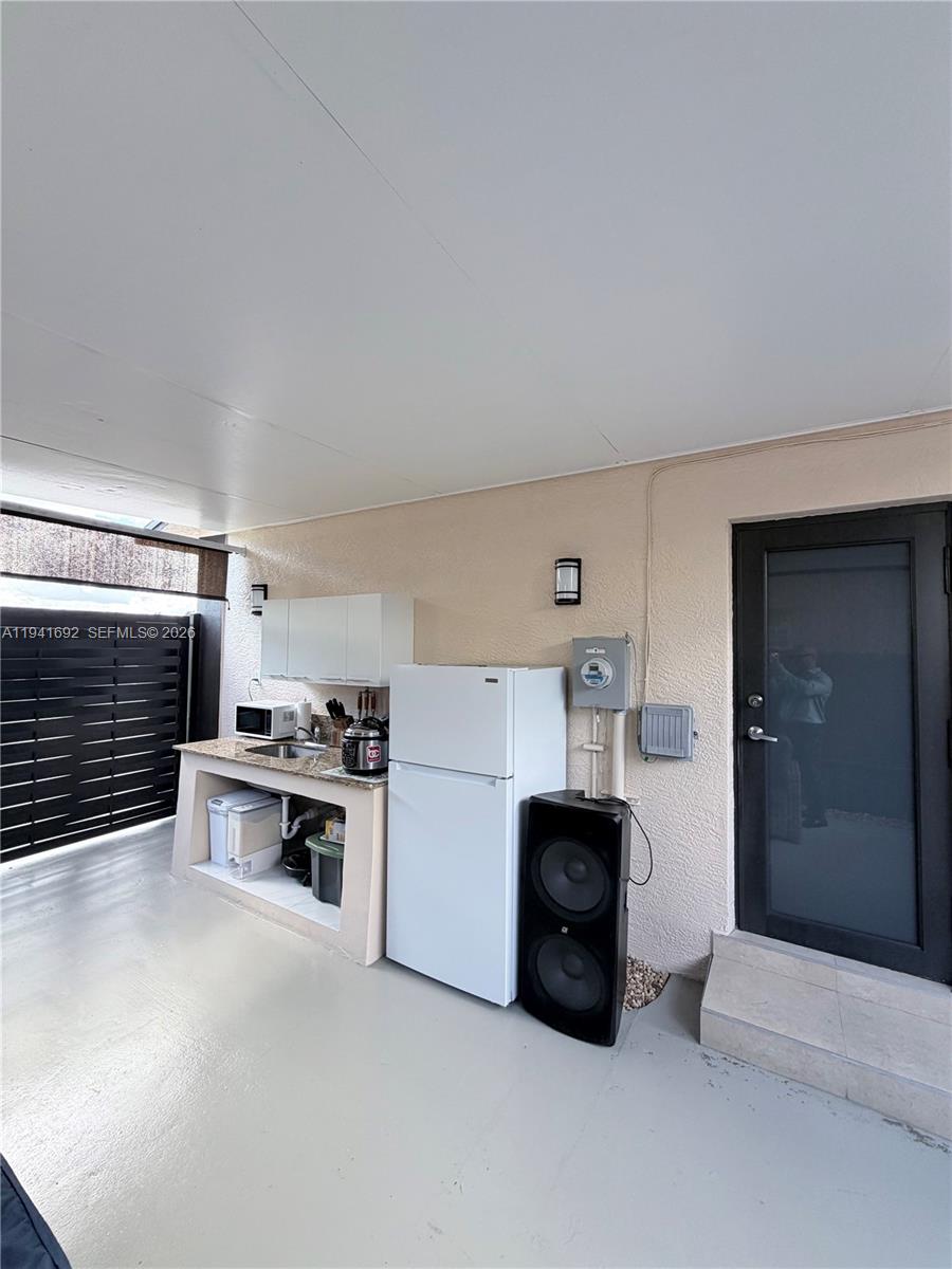 13261 Southwest 260th Terrace Homestead, FL 33032 - Photo 17 of 36 a kitchen with a sink and a stove top oven