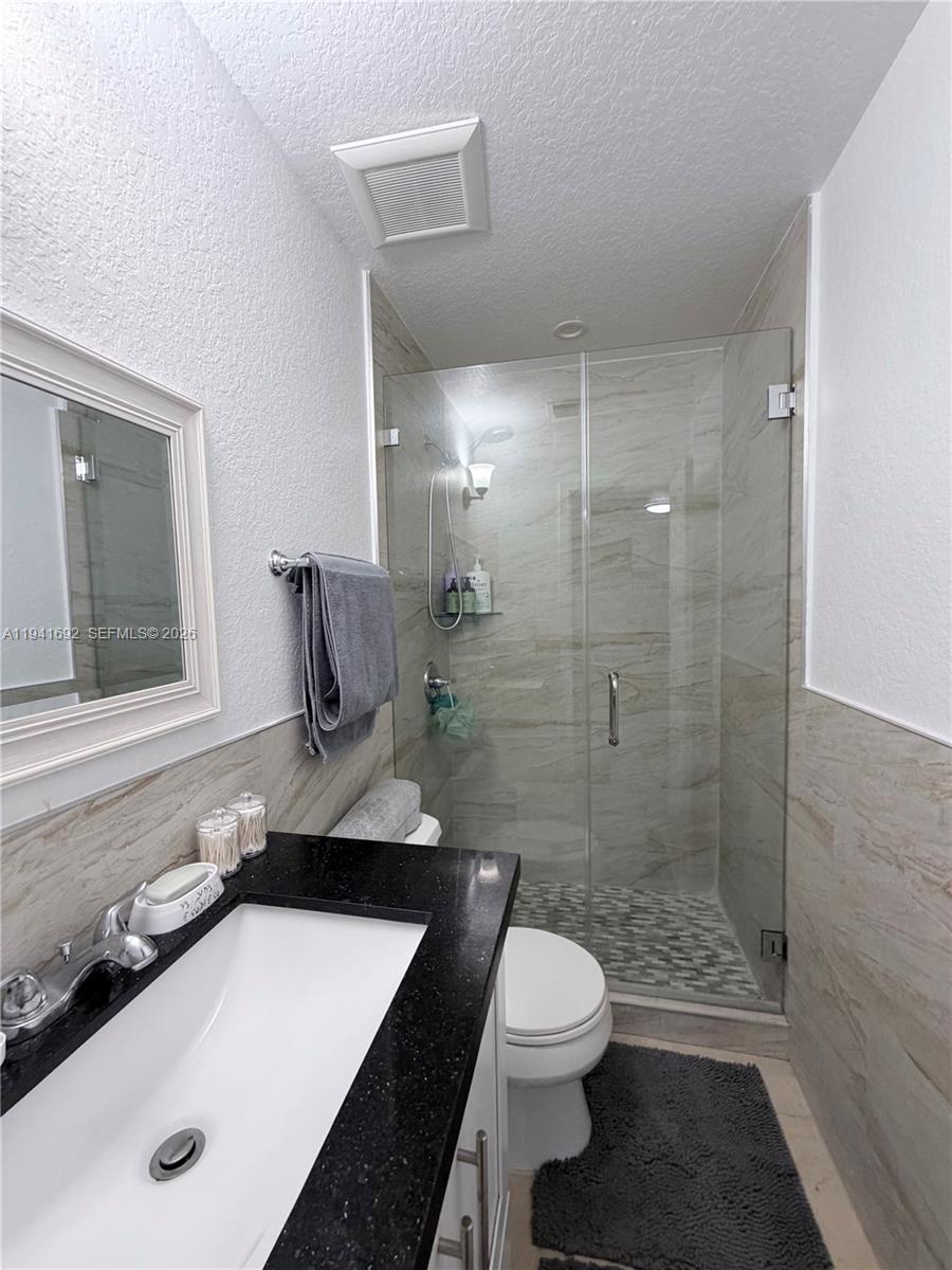 13261 Southwest 260th Terrace Homestead, FL 33032 - Photo 20 of 36 a bathroom with a sink a toilet and shower