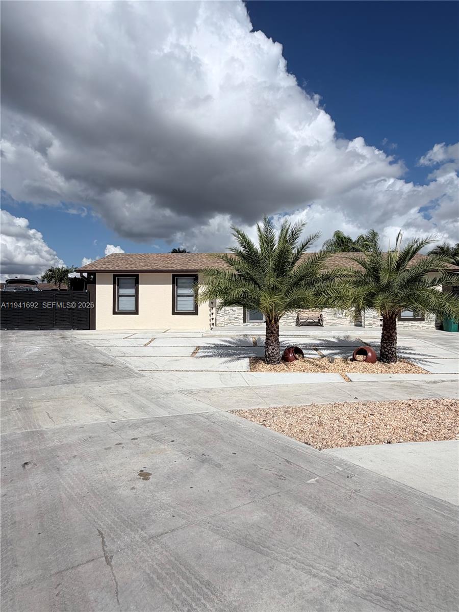13261 Southwest 260th Terrace Homestead, FL 33032 - Photo 2 of 36 a view of a house with a yard