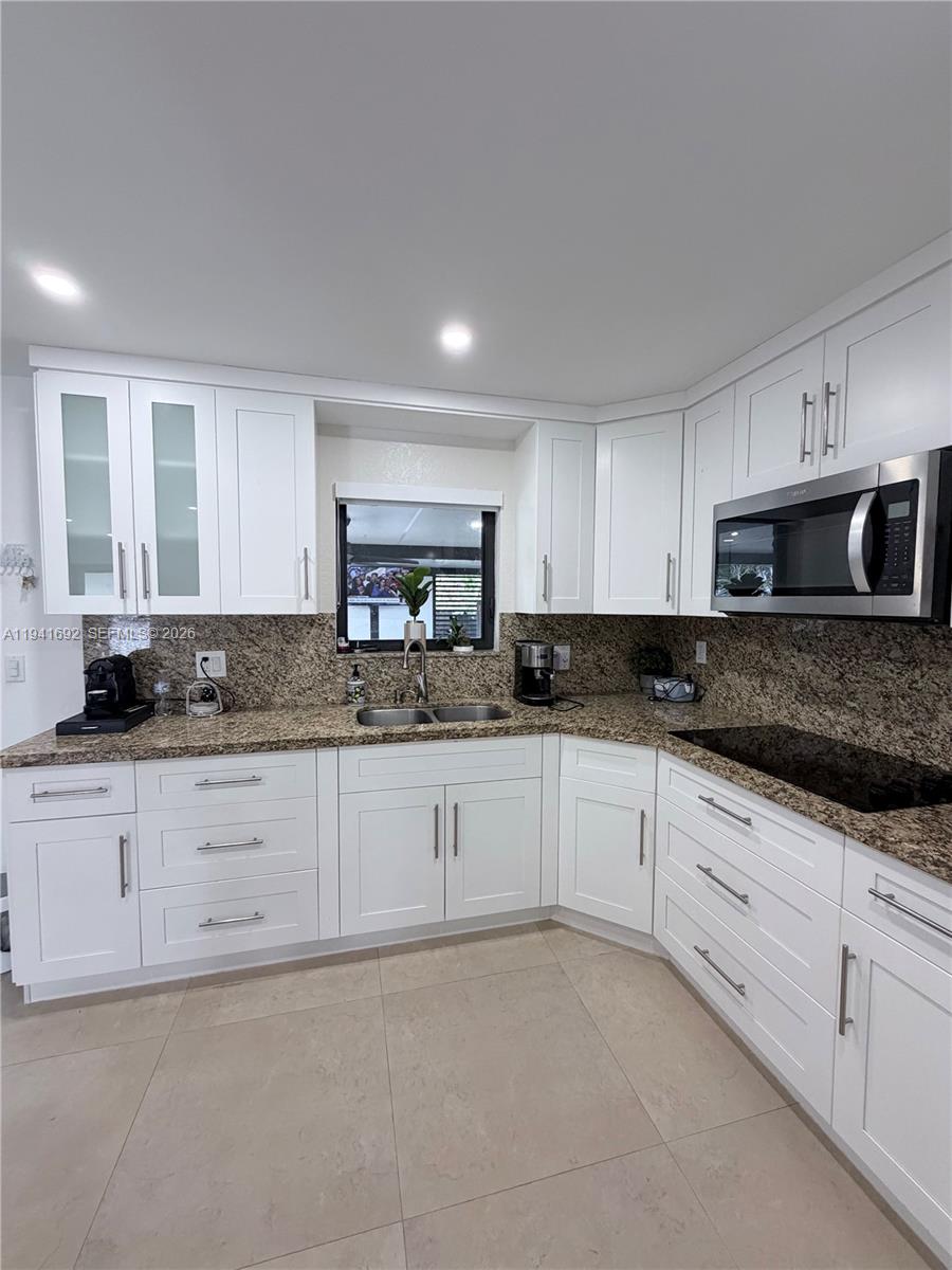 13261 Southwest 260th Terrace Homestead, FL 33032 - Photo 23 of 36 a kitchen with granite countertop white cabinets white stainless steel appliances and a sink