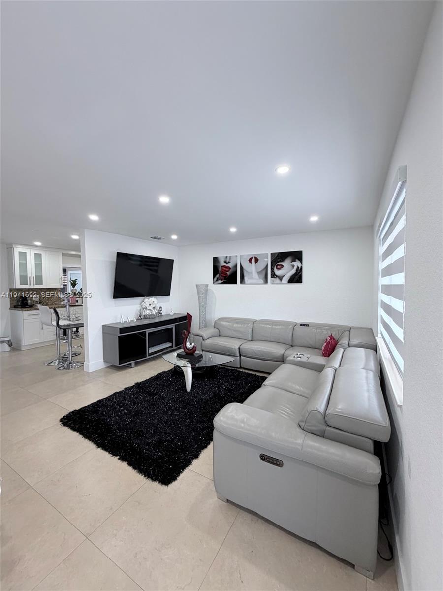 13261 Southwest 260th Terrace Homestead, FL 33032 - Photo 27 of 36 a living room with furniture and a flat screen tv