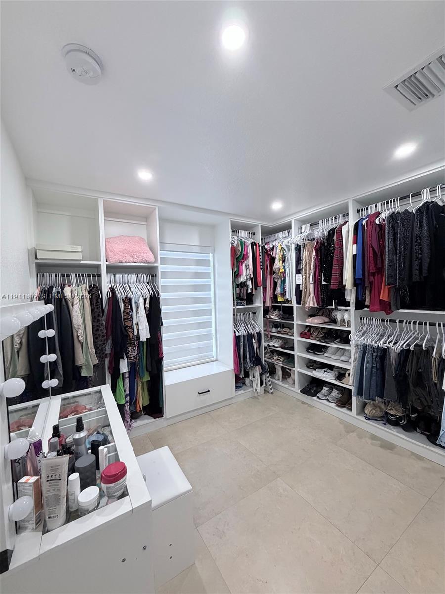 13261 Southwest 260th Terrace Homestead, FL 33032 - Photo 29 of 36 a view of walk in closet with clothes and shoes